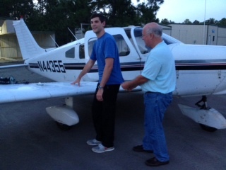 John Jones CFI Cutting a solo shirt for MidCoast Aviation Services